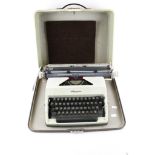 A vintage 'Olympia' portable manual typewriter in case.