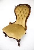 A vintage mahogany framed button back nursing chair.