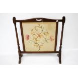 A Victorian mahogany framed fire screen.