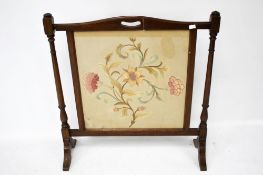 A Victorian mahogany framed fire screen.