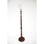 A vintage stained wooden floor lamp.