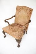 A carved and upholstered library open armchair.