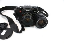 A Leica R4s Elcovision 35mm film camera and two lenses.