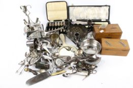 An assortment of silver plate. Including boxed flatware, sewing scissors, thimbles, etc.