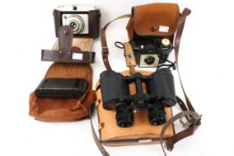 A pair of Schooner 8x30 binoculars and three cameras.