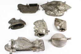 A collection of late 19th century tin two-part chocolate moulds. Including a dancing elephant, H16.