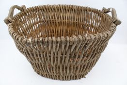 A large wicker log basket with wooden handles (AF).