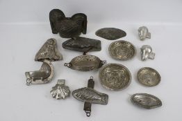 A collection of late 19th century tin chocolate moulds.