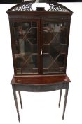 A mahogany display cabinet on stand. Astral glazed and blind frieze below.