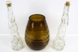 A vintage smoked ridged glass vase and two novelty bottles.