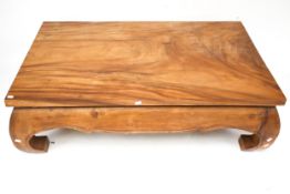 A contemporary Chinese style hardwood coffee table.