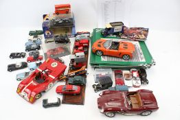 A collection of assorted diecast model cars and car magazines.
