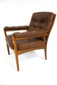 A Swedish Gote Mobel lounge open armchair. With chestnut leather button back cushions.