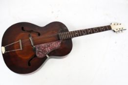 A vintage acoustic six string guitar.