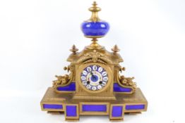 A brass and blue enamel eight-day mantel clock.