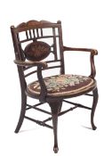A late Victorian black walnut inlaid chair.