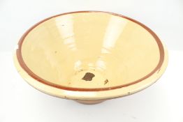 A large vintage terracotta pancheon cream glazed bread proving mixing bowl.
