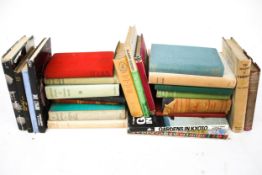 A collection of books. Including 'The Creative Experiment' by C. M.