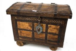 A vintage style hardwood and metal bound wheeled trunk chest.