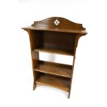 An oak Arts and Crafts freestanding bookcase. Labelled 'James Baildom, Louth' on the back.