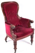 A Victorian mahogany library chair with spoon shaped back.