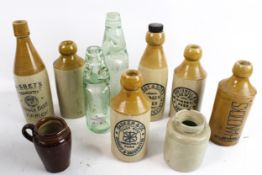 A collection of vintage stoneware bottles and two Codd bottles.