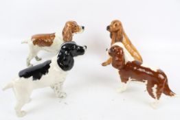 Four porcelain models of spaniel dogs. Comprising three Beswick and one Coalport. Max. H14.