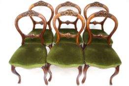 A set of six mid-Victorian balloon back dining chairs.