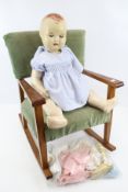 1950s Sarold doll and a small rocking chair.