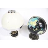A twelve inch terrestrial globe and a dome top table lamp.