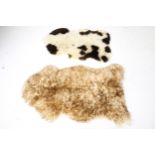 Two sheepskin fur rugs.