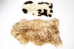Two sheepskin fur rugs.