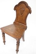 A Victorian oak hall chair.