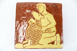 An Andrew McGarva Studio Pottery slipware tile. 'Shepherd shearing a sheep', 14.