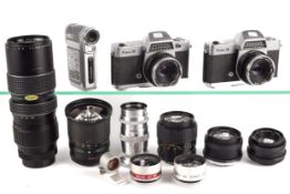 A collection of vintage film cameras and lenses.