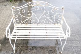 A white painted metal garden bench.