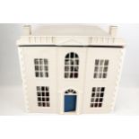 A contemporary plywood dolls house In the Georgian style.