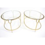 A pair of oval gilt metal framed glass topped coffee tables.