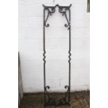 A pair of wrought iron work cross beams.