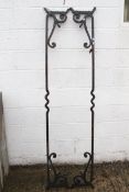 A pair of wrought iron work cross beams.
