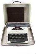 A vintage 'Olympia' portable manual typewriter in case.