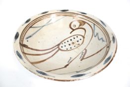 Studio Pottery : A large stoneware pottery bowl decorated with a bird. Circa H11cm x diameter 44.