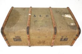 A vintage wooden bound and canvas travel trunk.