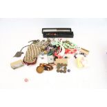 An assortment of costume jewelry. Including necklaces, hairpieces, a purse, locket, etc.