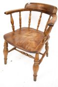 A vintage smoker bow elm open armchair. Raised on turned tapering supports with twin stretchers.