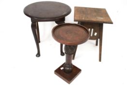 A early 20th century plant stand and two circular top tables.