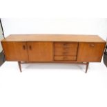 Vintage Retro : A G-Plan red teak sideboard. Standing on turned tapering short legs, H79cm x W205.