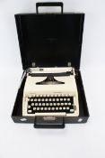 A cream 1970s portable Remington Ten Forty mechanical typewriter.