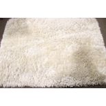 A Dunhelm 'Jewel Shaggy' ivory rug.