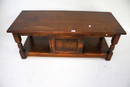 A Woods Bros Old Charm 20th century stained oak coffee table.